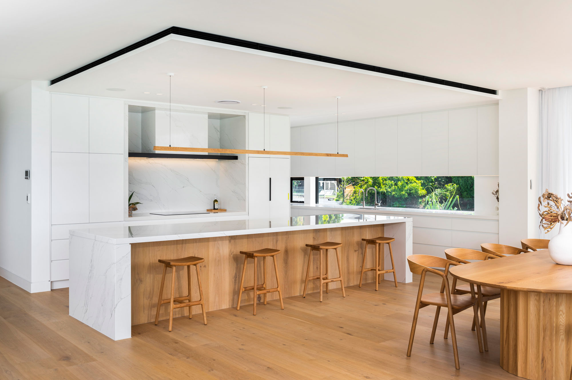 Tenn Linear Pendant made in White Oak and installed in a modern kitchen